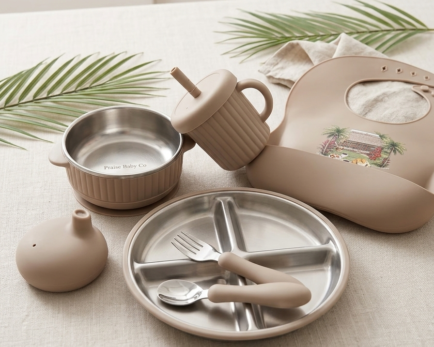Children's tableware set including plate, cups, and cutlery on a neutral background with graphic on bib and Praise Baby Co logo.